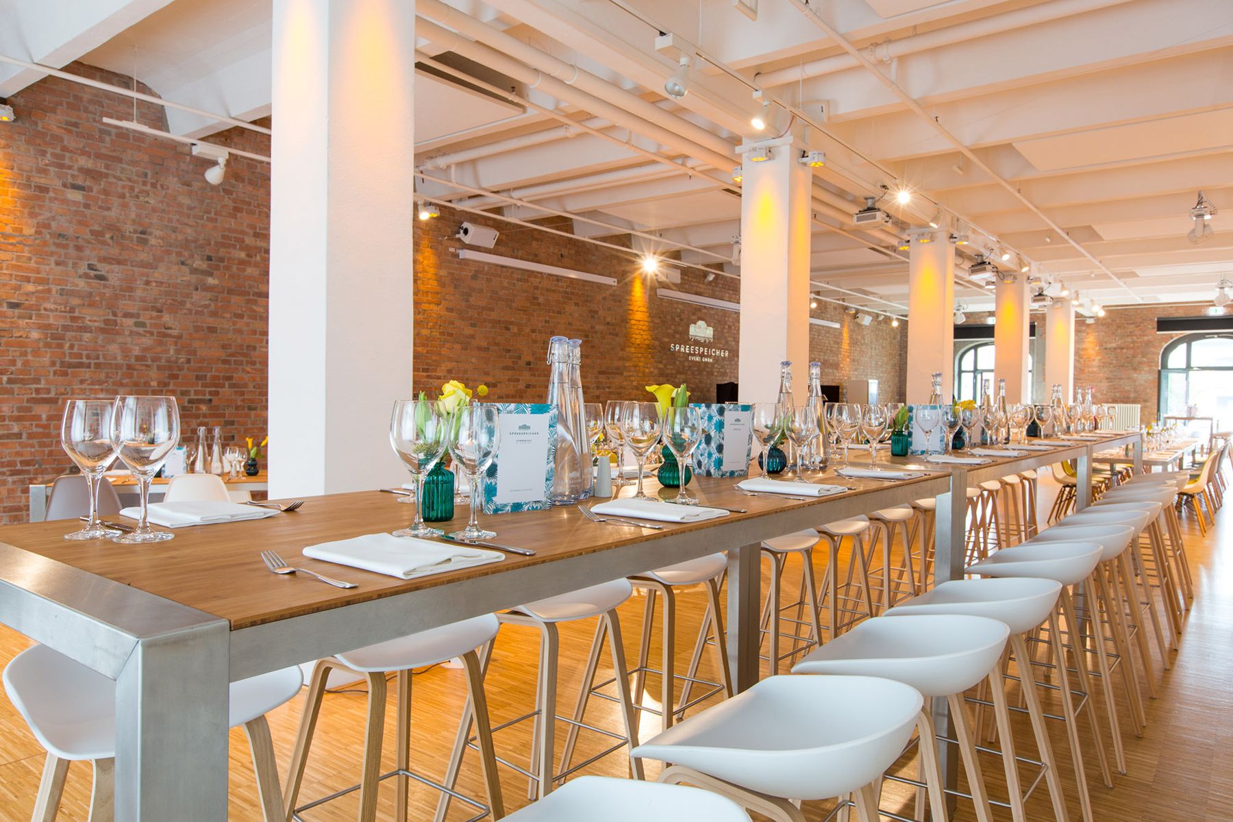 Long laid table beside large windows