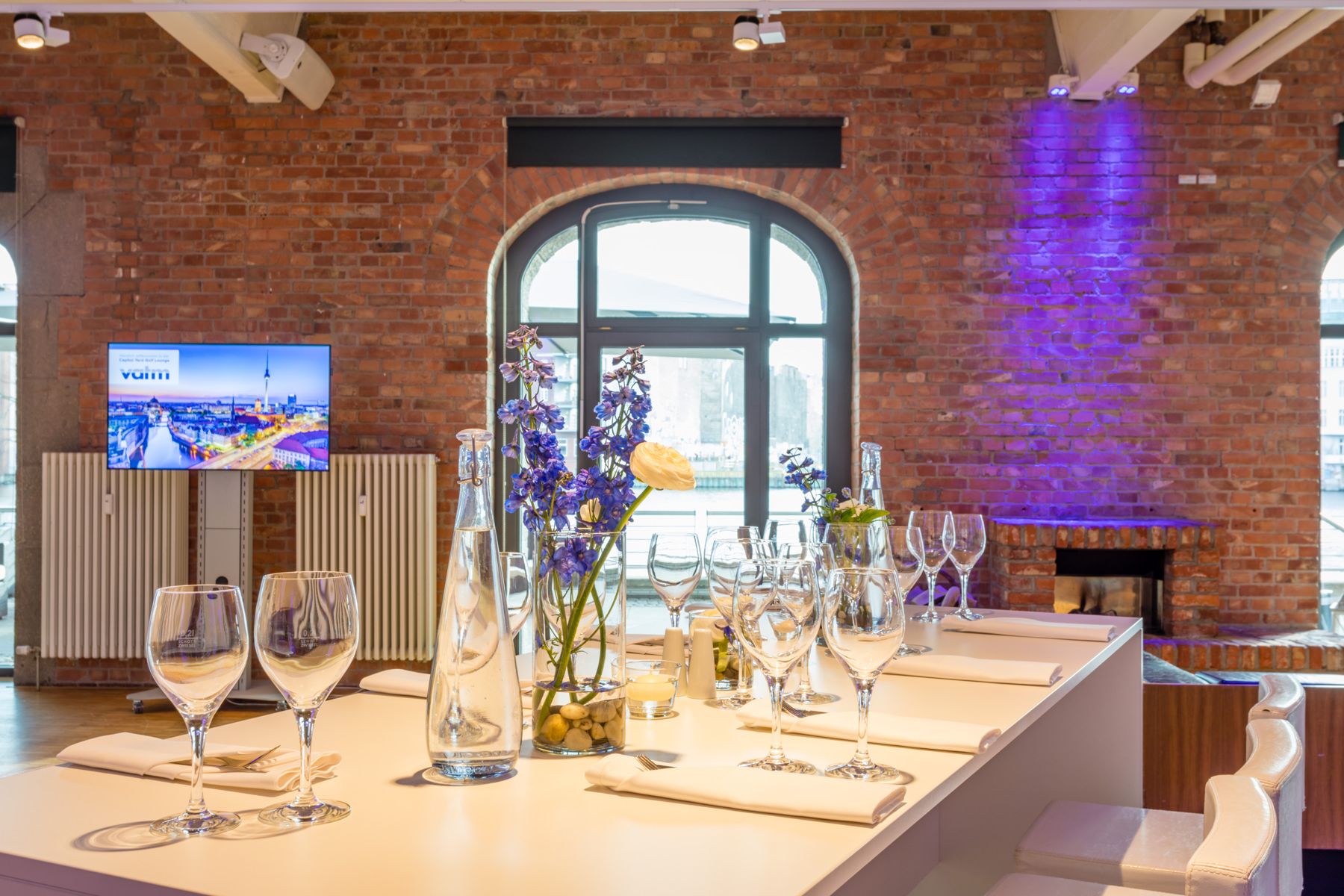 Laid table beside a brick wall and arched window