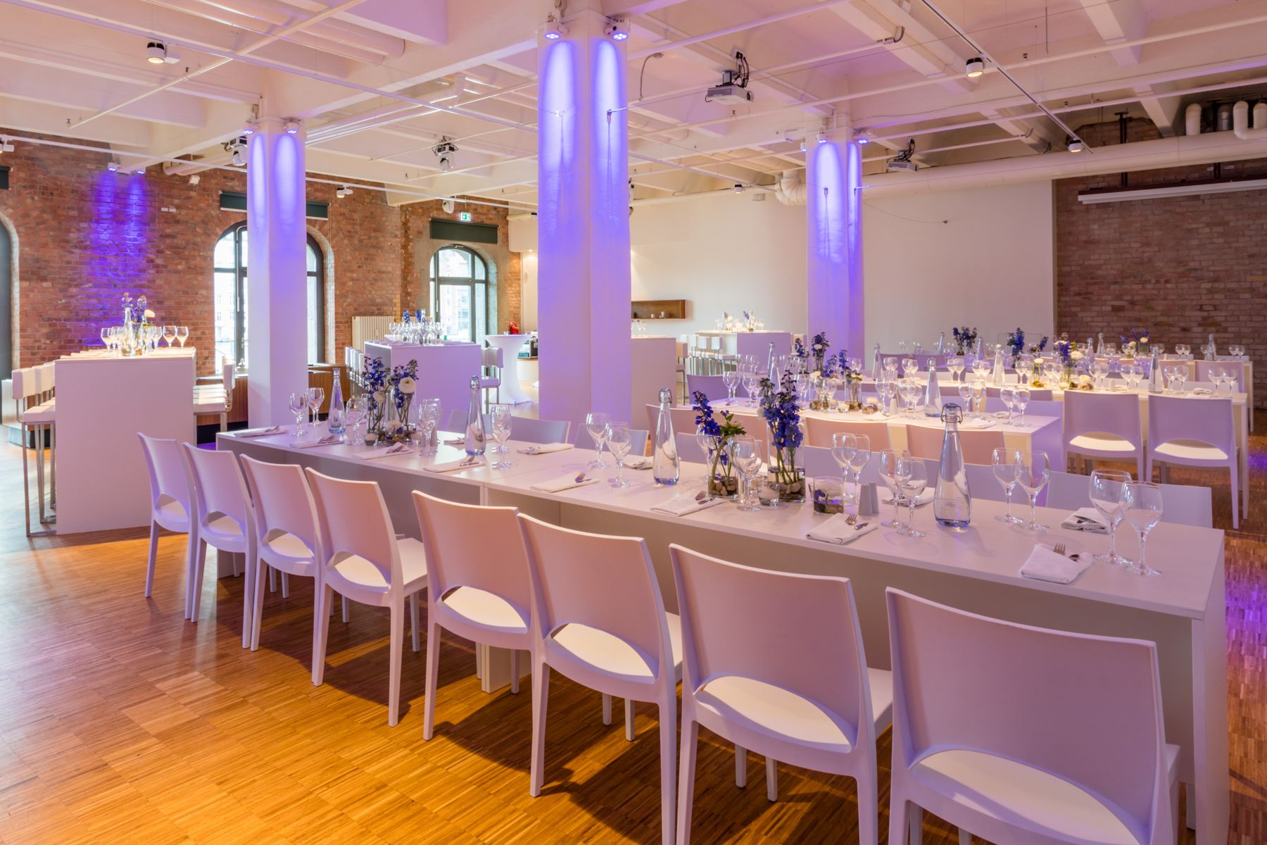 Laid long tables under purple lighting
