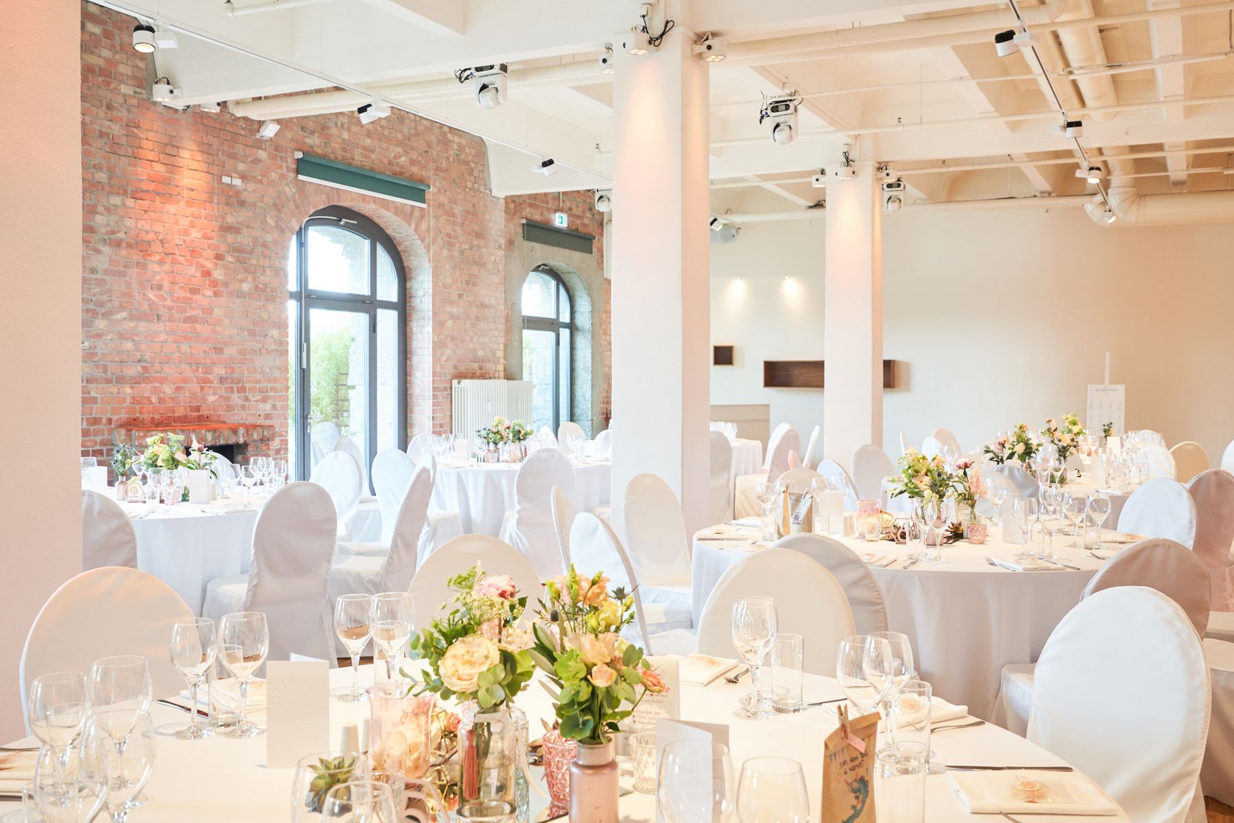 White wedding seating and floral decorations in the hall